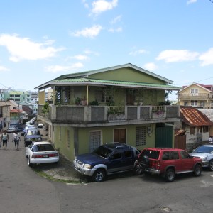 A nicer house in Roseau. The parked cars give a sense of how hard it is to get around as a pedestrian.