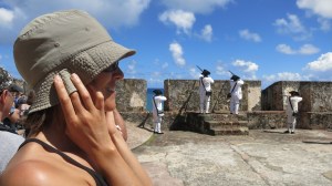 Megan holds her ears while volunteers demonstrate shooting muskets