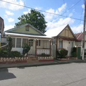Traditional architecture and conch shell decorations on two small houses in Anse La Raye