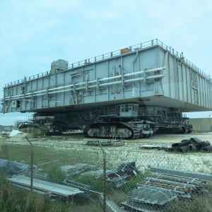 The "Crawler" at Kennedy Space Center with a platform on top. Rockets are transported on top of this from the assembly to the launch. Empty it weighs about 6 million pounds, can travel up to 2 mph,  and takes a team of 30 to operate it.
