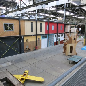 Inside the giant old shipyard warehouse at NDSM. Artists and others have made little work spaces out of old containers.
