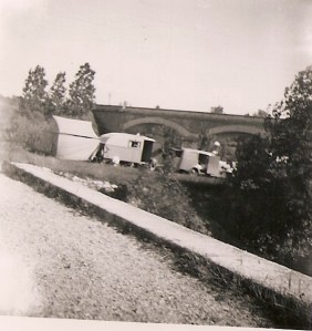 A picture taken by Jim's mom in 1952 of a Roma camp in front of a bridge.
