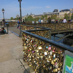 "Love" locks have taken over bridges in Paris. The weight of all these locks is causing structural problems and the city has to cut them down and is replacing the wire with glass panels.