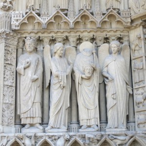 St Denis is the headless guy. The legend says he was decapitated, picked up his head, and walked 10k while preaching before he died.