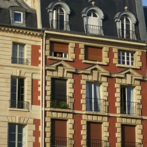 Look for the woman doing two things Parisians do well: reading and smoking.