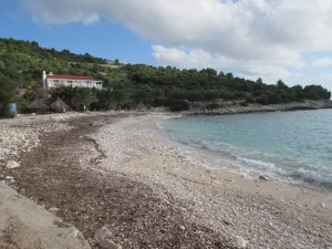 A typical rugged Croatian beach: white rocks, blue water.